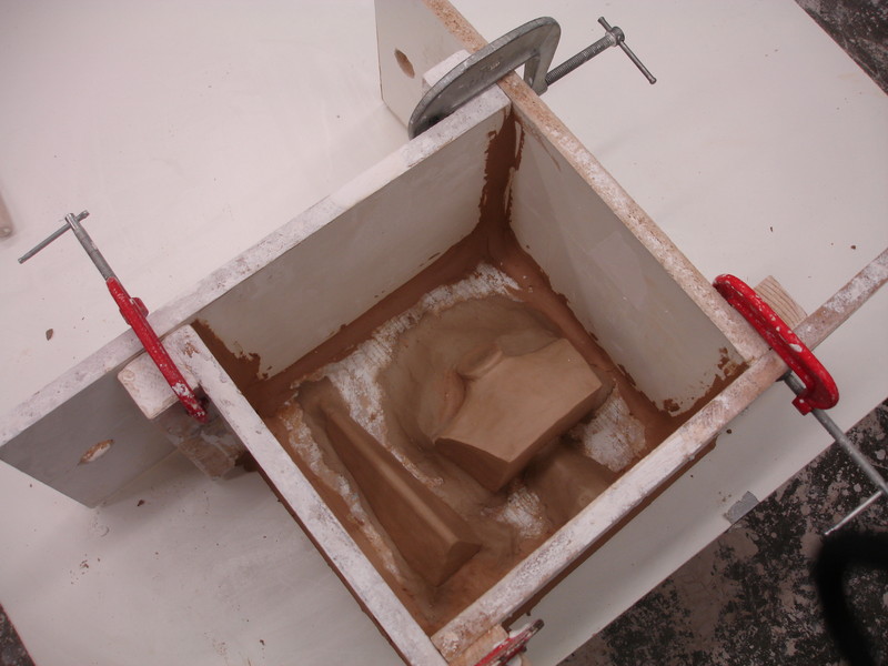 Conqueror wip | Secure the boards around the model and seal the gaps with more clay